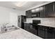 Well-appointed kitchen with dark cabinets, stainless steel appliances, and plenty of counter space at 14914 Flowing Gold Dr, Bradenton, FL 34212