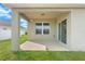 Covered porch with neutral tones, featuring a sliding door and window facing the green lawn at 14914 Flowing Gold Dr, Bradenton, FL 34212