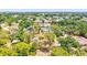 Aerial view of the property showcasing the house, lush greenery, and the surrounding neighborhood at 1518 Stoeber Ave, Sarasota, FL 34232