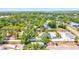 Aerial view of a home with a swimming pool surrounded by lush green trees and shrubbery at 1518 Stoeber Ave, Sarasota, FL 34232
