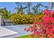 Inviting backyard with a hot tub, colorful flowers, and plenty of space for outdoor enjoyment at 1518 Stoeber Ave, Sarasota, FL 34232