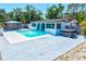 Spacious backyard with a pool, hot tub, and covered patio, perfect for outdoor entertaining at 1518 Stoeber Ave, Sarasota, FL 34232