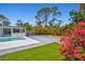 Tranquil pool and backyard with lush landscaping and a hot tub, creating a private oasis at 1518 Stoeber Ave, Sarasota, FL 34232