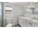Bright bathroom featuring dual sinks with marble countertop, and white cabinetry at 1518 Stoeber Ave, Sarasota, FL 34232