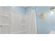 Shower with white tile, shower curtain, and blue walls at 1518 Stoeber Ave, Sarasota, FL 34232