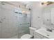 Updated bathroom featuring marble-style tile, a glass enclosed shower, and a white vanity at 1518 Stoeber Ave, Sarasota, FL 34232