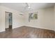 Bright bedroom features hardwood floors, ceiling fan, and natural light at 1518 Stoeber Ave, Sarasota, FL 34232