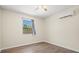 Well-lit bedroom with wood-look flooring and a window offering natural light at 1518 Stoeber Ave, Sarasota, FL 34232