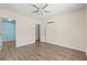 Bedroom with hardwood floors, ceiling fan, and an attached closet at 1518 Stoeber Ave, Sarasota, FL 34232
