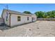 Back of a cozy home with a large backyard providing privacy, ample parking, and storage space at 1518 Stoeber Ave, Sarasota, FL 34232