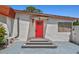 Close-up of the front entrance with a stylish red door and modern exterior lighting at 1518 Stoeber Ave, Sarasota, FL 34232