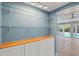 Hallway featuring display case, white cabinets, and a view of the pool and backyard at 1518 Stoeber Ave, Sarasota, FL 34232