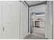 Hallway with a stainless steel refrigerator and view of the bright kitchen at 1518 Stoeber Ave, Sarasota, FL 34232