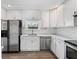Kitchen featuring white cabinetry, stainless steel appliances, and hardwood floors at 1518 Stoeber Ave, Sarasota, FL 34232
