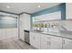 Bright kitchen features gray countertops, light blue accent wall and a view of the pool at 1518 Stoeber Ave, Sarasota, FL 34232