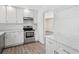 Bright kitchen with white cabinets, stainless steel appliances, and hardwood floors at 1518 Stoeber Ave, Sarasota, FL 34232