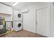 Functional laundry room featuring a stacked washer and dryer and ample storage at 1518 Stoeber Ave, Sarasota, FL 34232