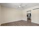 Minimalist living room featuring wood-look floors and great sunlight, leading into the kitchen at 1518 Stoeber Ave, Sarasota, FL 34232