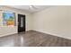 Bright living room featuring wood floors, new paint, a window, and modern fixtures at 1518 Stoeber Ave, Sarasota, FL 34232