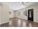 Open-concept living room featuring hardwood flooring, ceiling fans, and bright windows for maximum light at 1518 Stoeber Ave, Sarasota, FL 34232