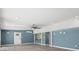 Spacious living area with stylish blue walls, modern ceiling fan, and plenty of natural light at 1518 Stoeber Ave, Sarasota, FL 34232