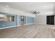 Open-concept living area with breakfast bar to the kitchen, modern ceiling fan and a door to the backyard at 1518 Stoeber Ave, Sarasota, FL 34232