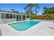 Backyard pool with a gray sundeck and covered patio creating a relaxing retreat at 1518 Stoeber Ave, Sarasota, FL 34232