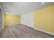 Large room with yellow walls, white doors, and vinyl floors at 1518 Stoeber Ave, Sarasota, FL 34232