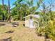 View of a well-maintained shed with tropical plants in the backyard at 1518 Stoeber Ave, Sarasota, FL 34232