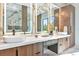 This primary bath features dual sinks, marble countertops, modern lighting, and a large glass shower at 1555 Eastbrook Dr, Sarasota, FL 34231