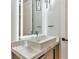 Bathroom close-up of a modern vanity with marble countertops, a unique faucet, and a lighted mirror at 1555 Eastbrook Dr, Sarasota, FL 34231