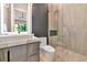 Modern bathroom featuring contemporary vanity, toilet, shower with glass door, and an accent wall at 1555 Eastbrook Dr, Sarasota, FL 34231