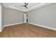 Spacious bedroom offers hardwood floors, recessed lights, tray ceiling with a fan, and pool views at 1555 Eastbrook Dr, Sarasota, FL 34231
