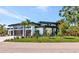 Modern home showcasing stylish architectural details, well-maintained landscaping, and a lush green lawn at 1555 Eastbrook Dr, Sarasota, FL 34231