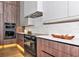 Modern kitchen featuring sleek cabinetry, stainless steel appliances, and a marble backsplash at 1555 Eastbrook Dr, Sarasota, FL 34231