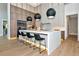 Modern kitchen with a large island, bar seating, stylish lighting, and sleek wood cabinetry at 1555 Eastbrook Dr, Sarasota, FL 34231