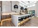 Bright kitchen with a large marble island, modern pendant lighting, and stainless steel appliances at 1555 Eastbrook Dr, Sarasota, FL 34231