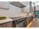 Modern kitchen featuring a stainless steel range hood, marble backsplash, and sleek cabinetry at 1555 Eastbrook Dr, Sarasota, FL 34231
