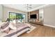 Relax in this primary bedroom featuring a ceiling fan, an entertainment center, and pool views at 1555 Eastbrook Dr, Sarasota, FL 34231