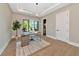 This home office offers a modern light fixture, built-in storage, and a large window overlooking the front yard at 1555 Eastbrook Dr, Sarasota, FL 34231