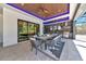 This outdoor dining area features a ceiling fan, recessed lighting, and a built-in outdoor kitchen at 1555 Eastbrook Dr, Sarasota, FL 34231