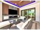 This outdoor living area boasts a ceiling fan, recessed lighting, a television, and comfortable seating at 1555 Eastbrook Dr, Sarasota, FL 34231