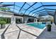 Expansive patio and pool area with a screened enclosure, featuring ample space for entertaining and lounging at 1555 Eastbrook Dr, Sarasota, FL 34231