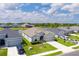 Aerial view of a well-maintained home and neighborhood with a serene pond at 16161 61St E Ln, Parrish, FL 34219