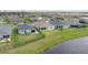 Aerial view of homes with well-maintained lawns, screened patios, and a serene pond in the neighborhood at 16161 61St E Ln, Parrish, FL 34219