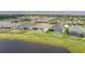 Beautiful aerial view of backyard homes overlooking the pond in a suburban community with manicured lawns at 16161 61St E Ln, Parrish, FL 34219