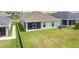 Spacious backyard with green lawn and a screened lanai, offering outdoor living and relaxation at 16161 61St E Ln, Parrish, FL 34219