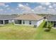 Lush backyard view featuring a screened lanai and well-maintained lawn and landscaping at 16161 61St E Ln, Parrish, FL 34219