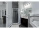 This lovely bathroom features gray tile backsplash, dark cabinets, and a glass shower at 16161 61St E Ln, Parrish, FL 34219