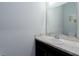 This cozy powder room features a single vanity, white cabinets, and neutral walls at 16161 61St E Ln, Parrish, FL 34219